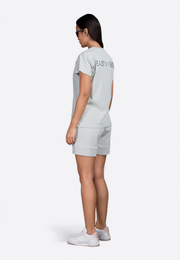 Model wearing greenback T-shirt, back view – East Vibe